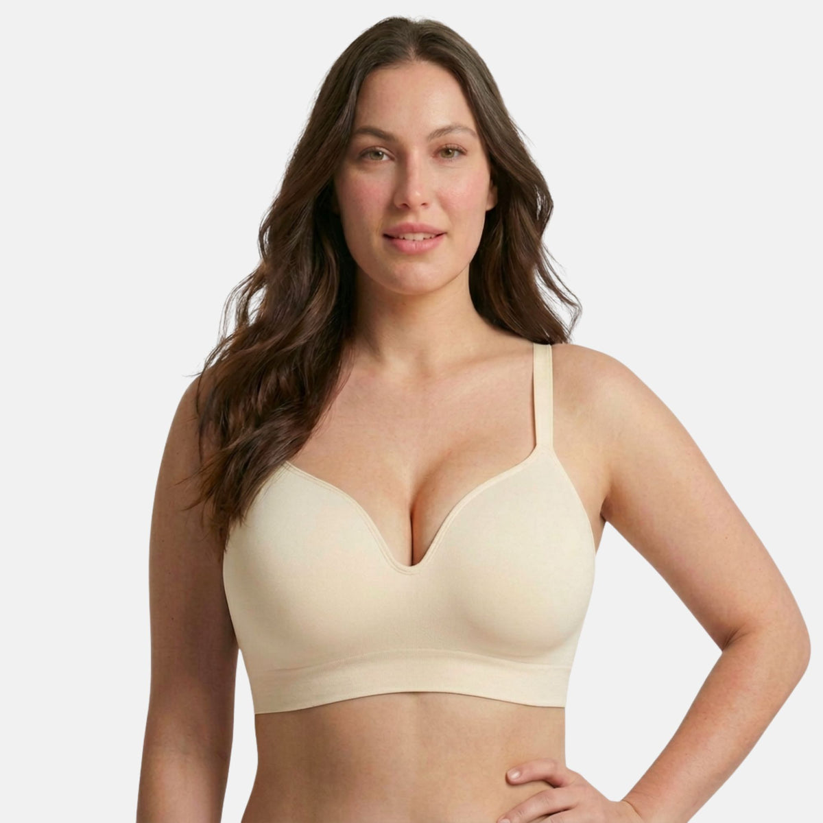 The Infinite Support Bra in Sand, worn by a model
